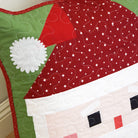 Quilted Santa Claus design on a wooden surface