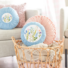 Kimberbell 12" round pillow insert with a cover on it 