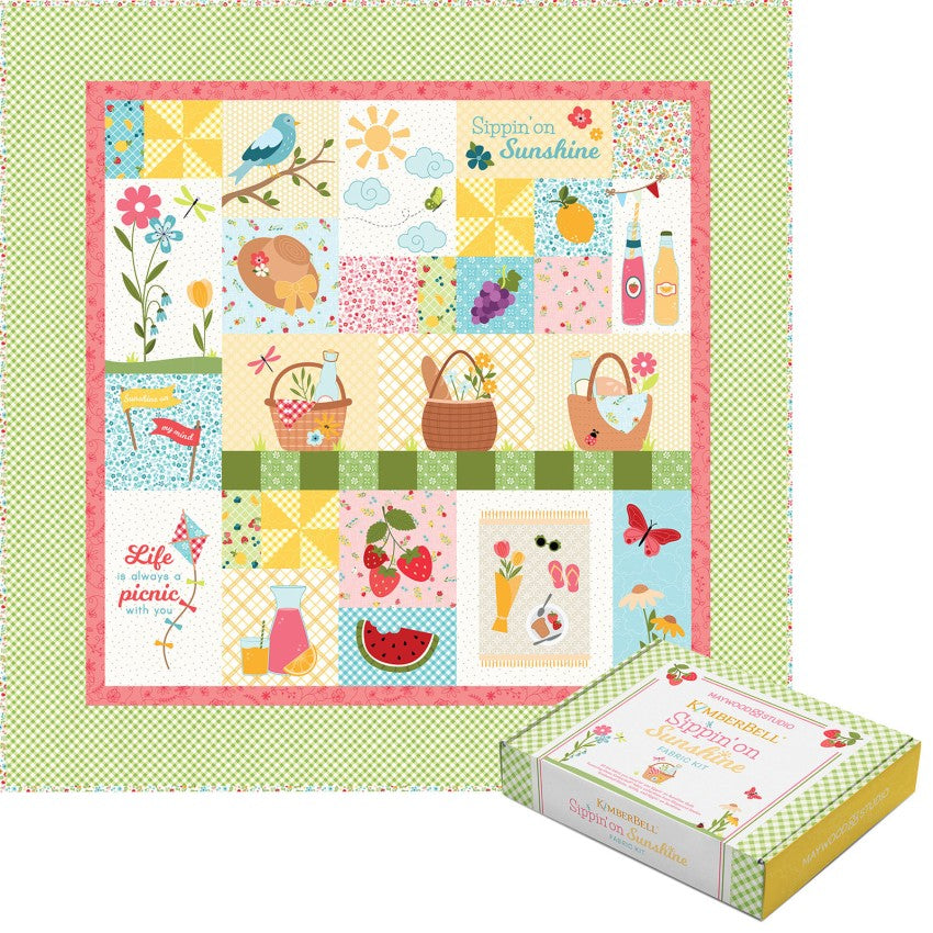 Colorful quilt with patchwork design featuring nature and picnic elements, displayed on a green polka dot background.