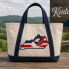 Tote bag with Kentucky design on a wooden surface with a scenic background
