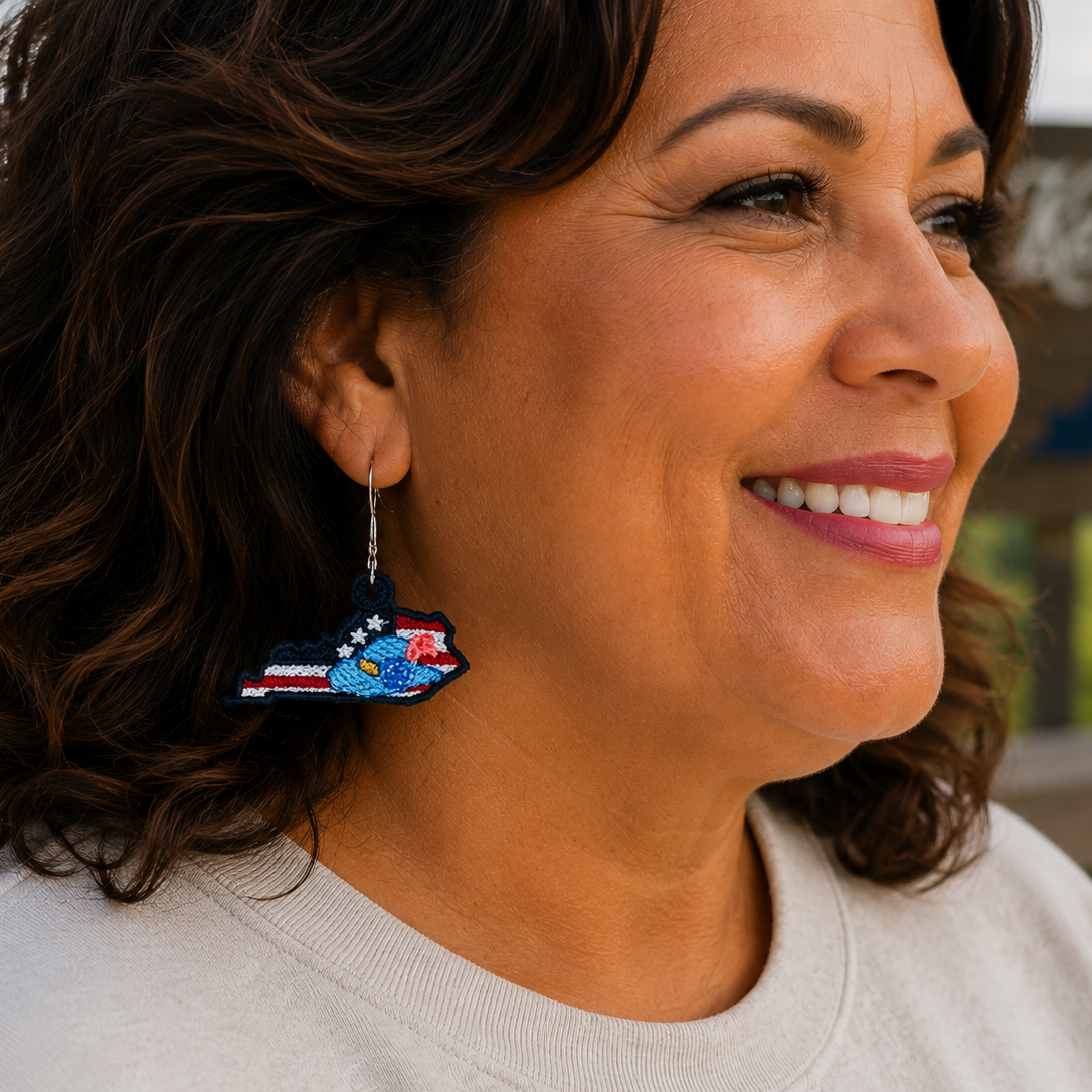 Woman wearing colorful earrings with a scenic background