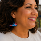 Woman wearing colorful earrings with a scenic background
