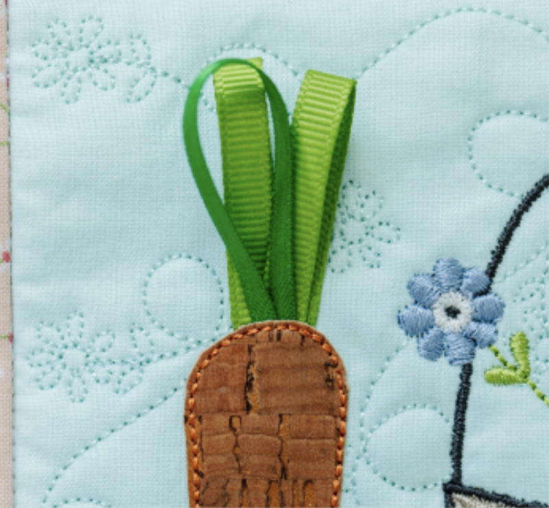 Ribbon carrot tops on the One Sweet Spring wall hanging.