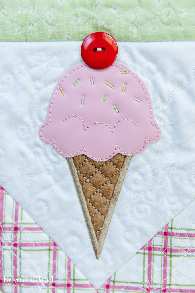 Close-up of embroidered ice cream cone made of leather and felt. 