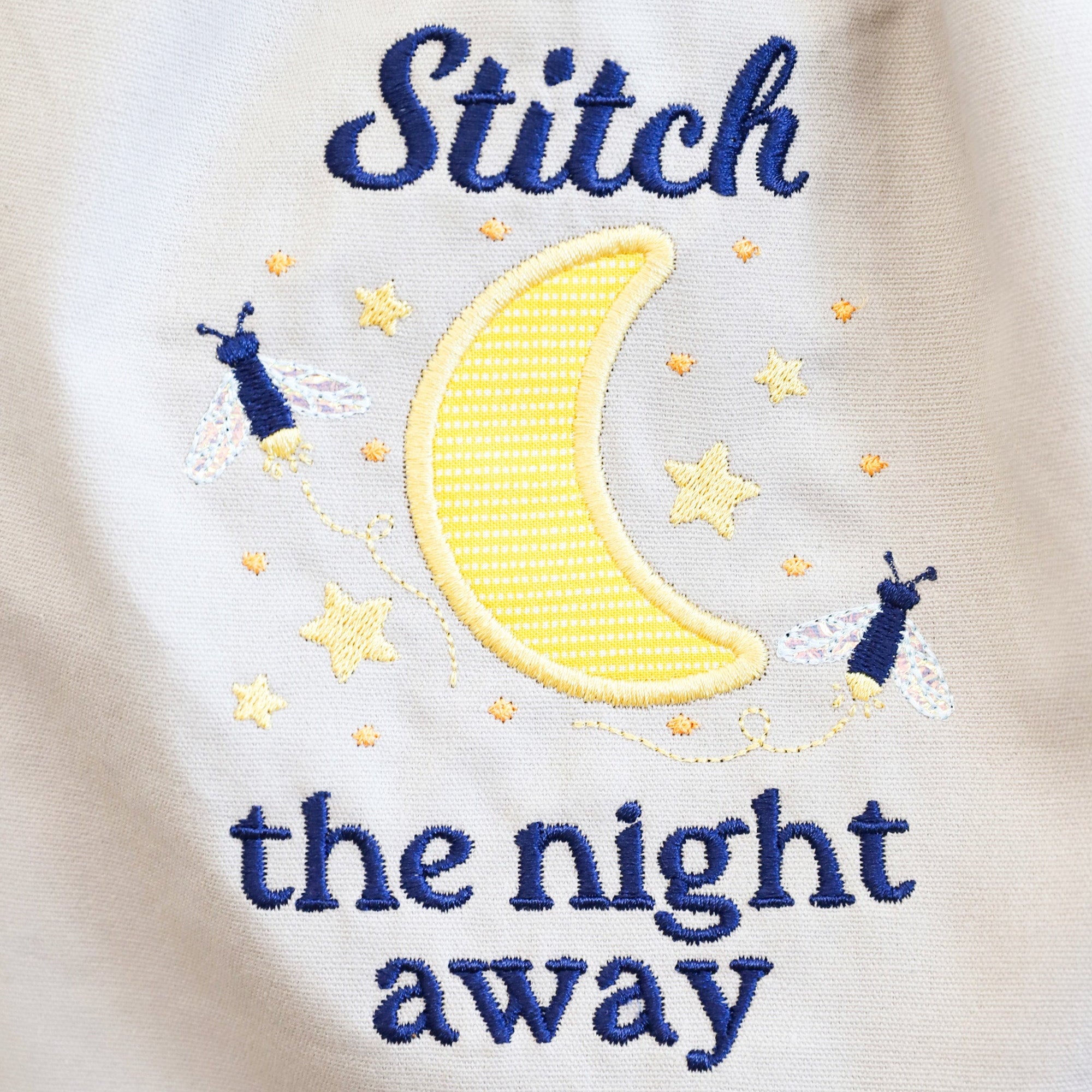 Embroidered design on fabric with 'Stitch the night away' text and moon and star illustrations.