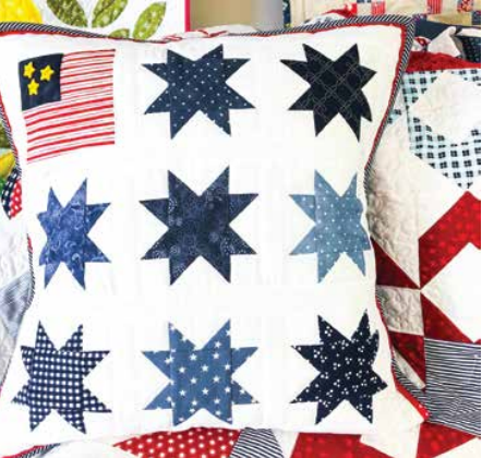 A square pillow with star-shaped quilt blocks.