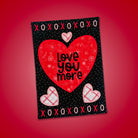 Card with red heart and 'Love You More' text on a red background
