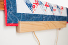 Close-up of a quilt with floral patterns and denim border on a white background 18" wall hanger