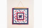 Quilt with red, white, and blue pattern hanging on a wall 18" wall hanger