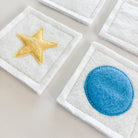 Felt patches with star and circle designs on a light background