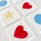 Colorful star and heart shapes on white square backgrounds