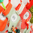 Colorful Christmas stockings hanging on a line with decorative elements.