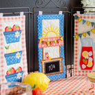 Decorative kitchen towels with summer-themed designs on a table.