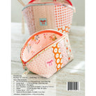 A fabric zippered pouch shown on a white background with a second matching pouch blurred behind it. The pouch has a pink base with white floral print and orange panels with white floral and bow patterns.