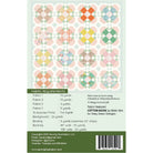 Back cover of a sewing pattern fabric book showing a grid of quilt pattern designs, fabric requirements, and a barcode on a white and green background.