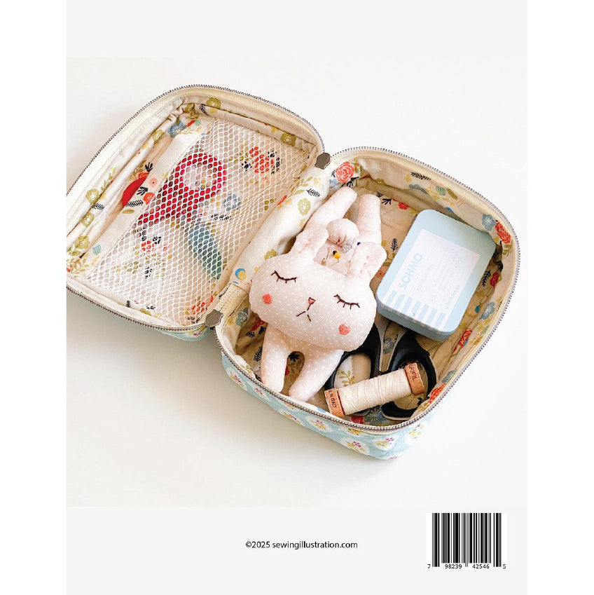 An open fabric zippered pouch with a floral print and mesh pocket, filled with sewing supplies including a plush bunny, thread spools, scissors, and a small blue box, photographed on a white background.