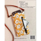 Floral patterned phone crossbody bag with zipper pocket on a beige background