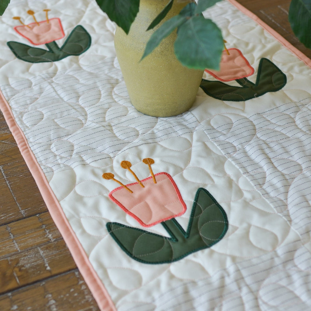 Potted plant on a quilt with floral designs