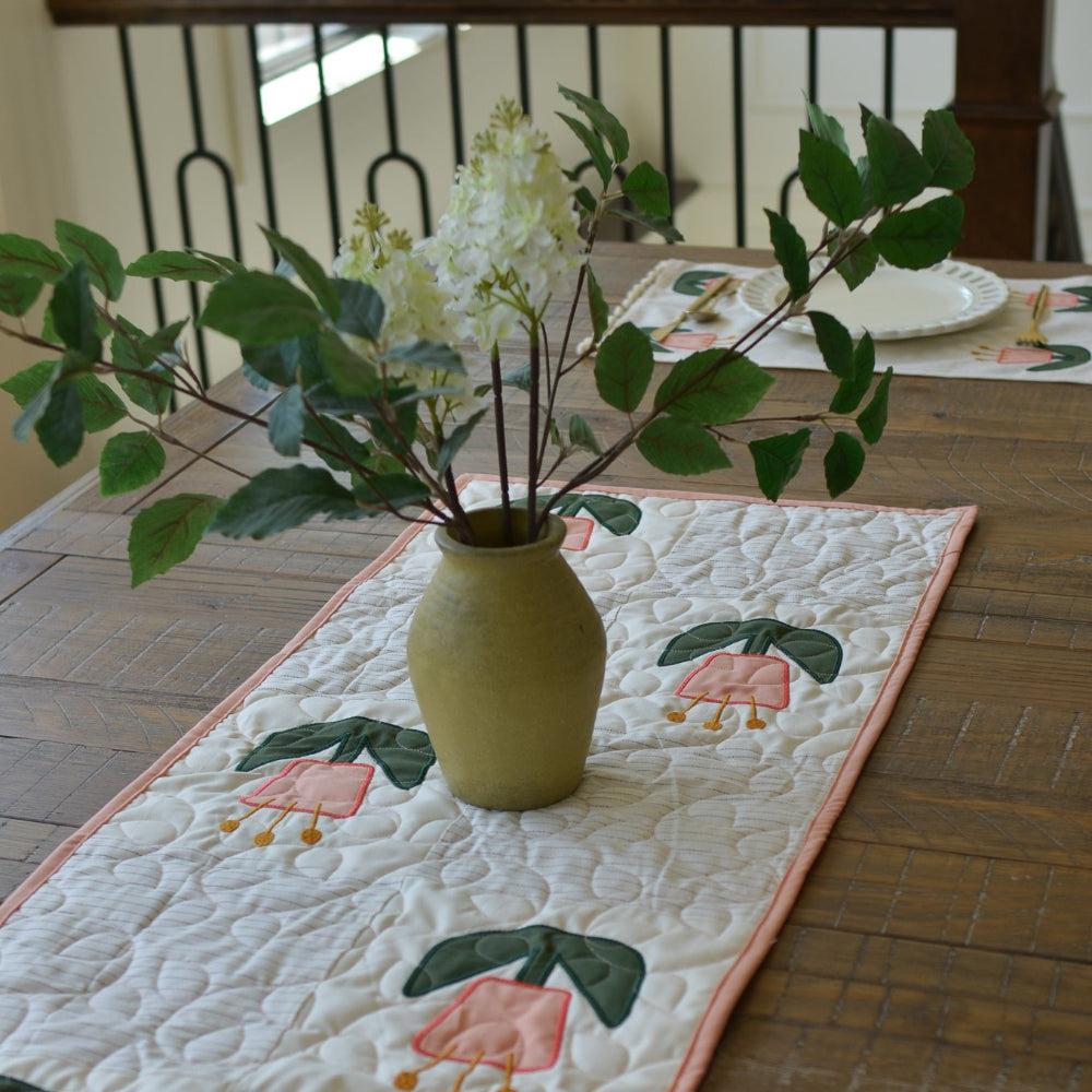 Decorative table runner with floral design on a wooden table