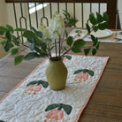 Decorative table runner with floral design on a wooden table