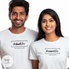 Two people wearing white t-shirts with '#dadlife' and '#momlife' text.