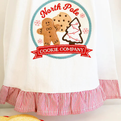 Towel with 'North Pole Cookie Company' design featuring gingerbread men and a cookie cutter.