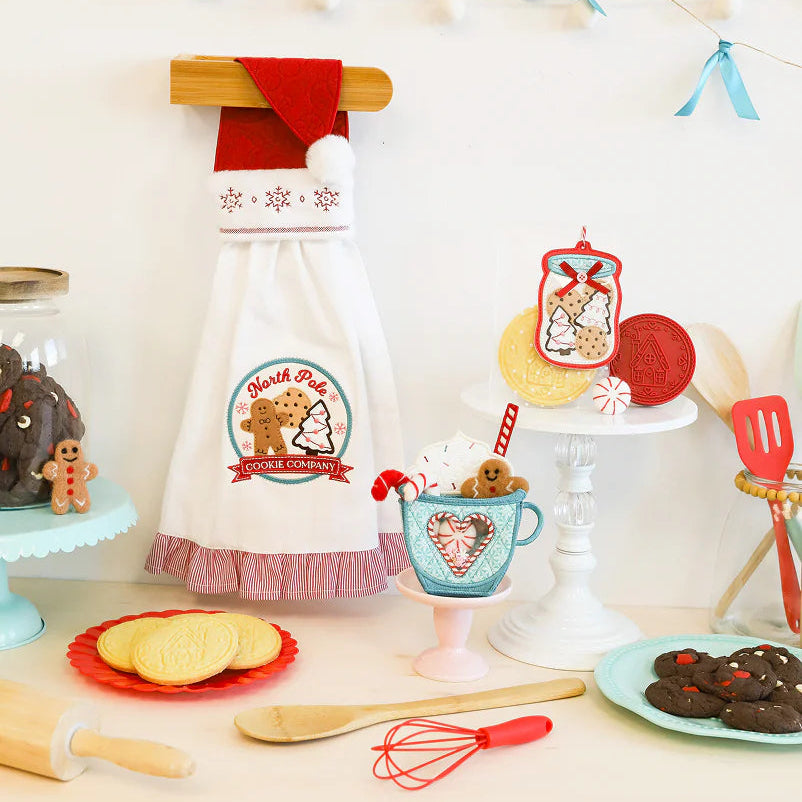 Decorative kitchen scene with a cookie-themed apron, baking utensils, and festive decorations.
