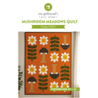 Sewing pattern cover for the Mushroom Meadows Quilt by my girlfriend's quilt shoppe, showing a completed orange quilt with white daisies, green leaves, and black-and-white mushrooms, with text indicating finished size 51 x 63 inches.