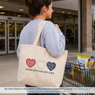 Woman carrying a tote bag with heart designs and text, standing outside a store.