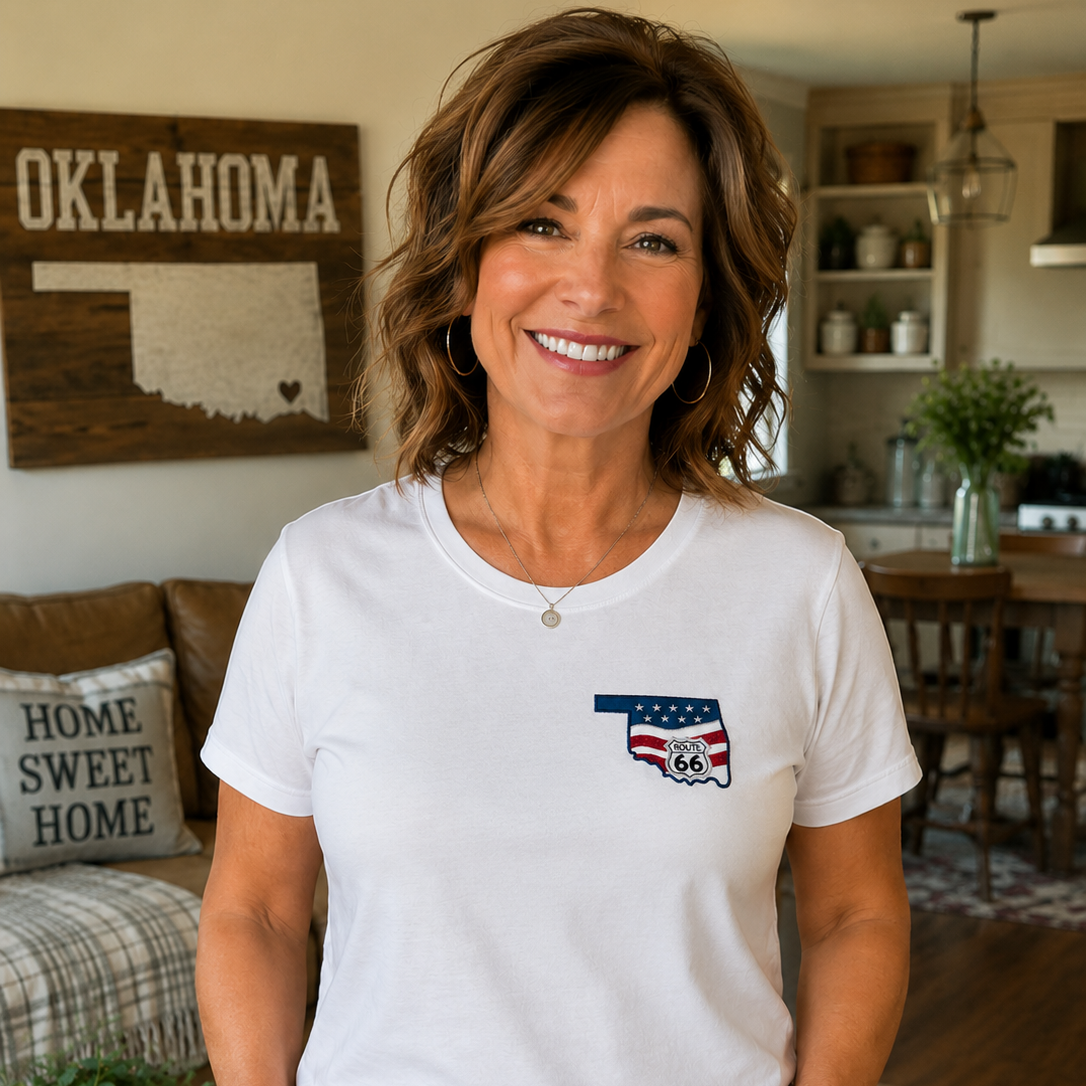 Woman wearing a white t-shirt with a logo in a living room setting