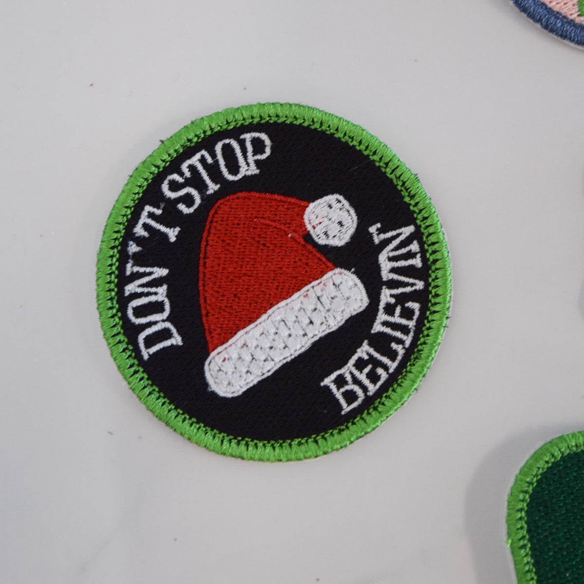 Embroidered patch with reindeer face and text on a white background