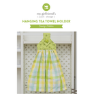 Hanging tea towel holder with green top and plaid pattern on a white background, featuring 'my girlfriend's quilt shoppe' branding.