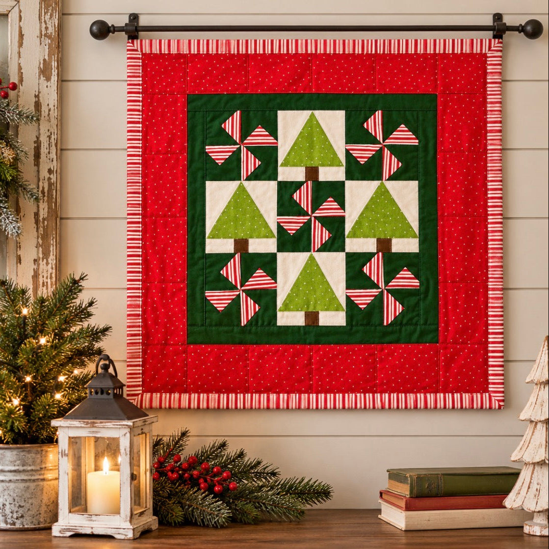 A festive Christmas quilted wall hanging displayed on a black rod against a beige wood-paneled wall. The quilt features a red outer border, a dark green inner field, and green tree and striped pinwheel motifs.