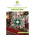 Sewing pattern cover for a 'Pieced Candy Cane Pillow' by my girlfriend's { quilt shoppe }, showing a finished 18" x 18" quilted pillow with a green, red, and white holiday design.