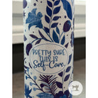 Tumbler with blue floral pattern and 'Pretty sure this is self-care' text on a white background