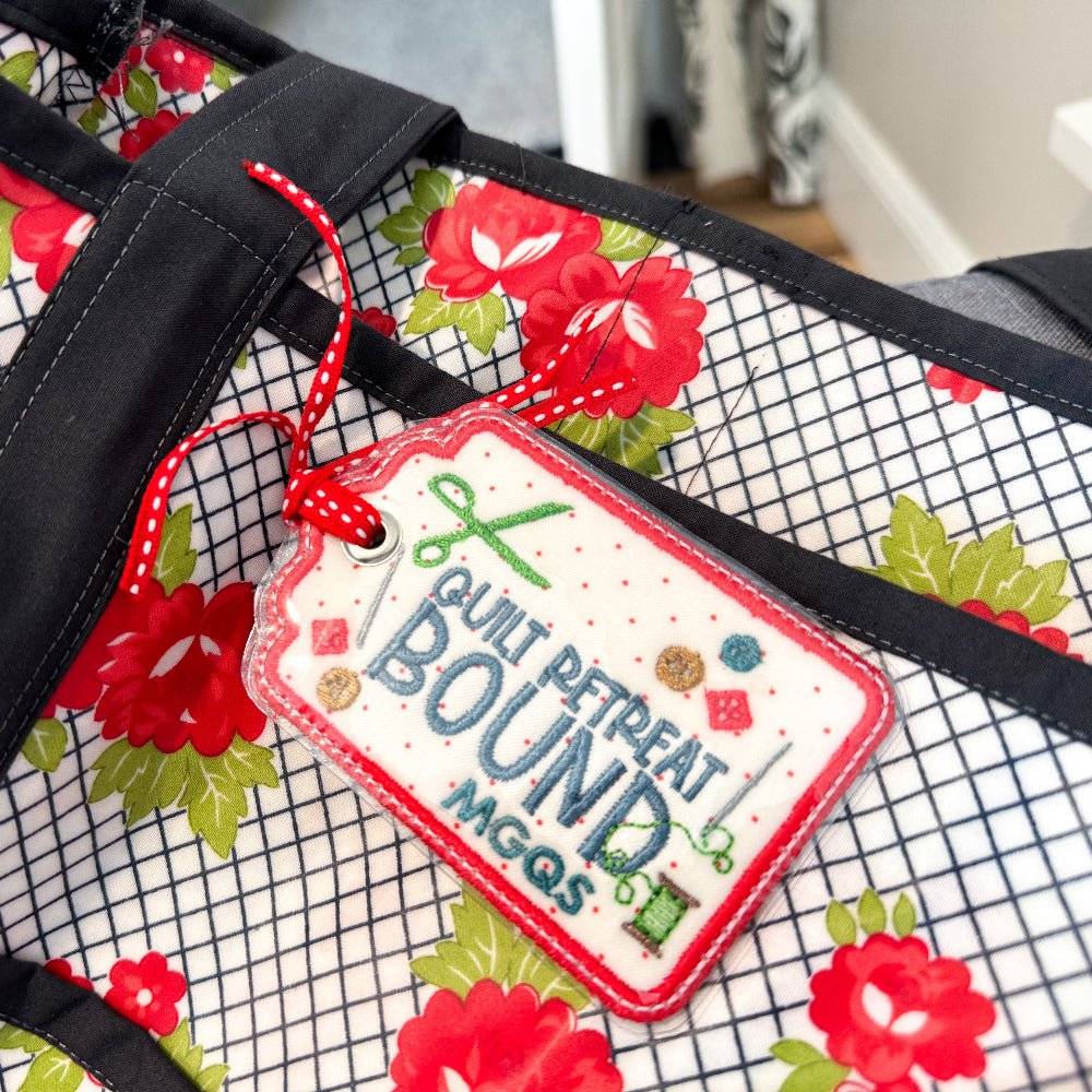 Floral-patterned bag with a 'Bout Pet Treats' tag on a checkered background