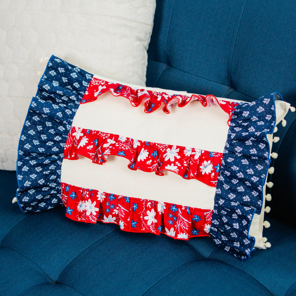 Decorative pillow with floral pattern on a blue couch