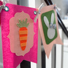 Decorative banner with a carrot and bunny design on a pink background.