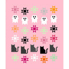 A pink square print or card featuring a grid of Halloween-themed quilt block designs, including white ghosts, black and gray cats, and multicolored star and geometric quilt patterns.