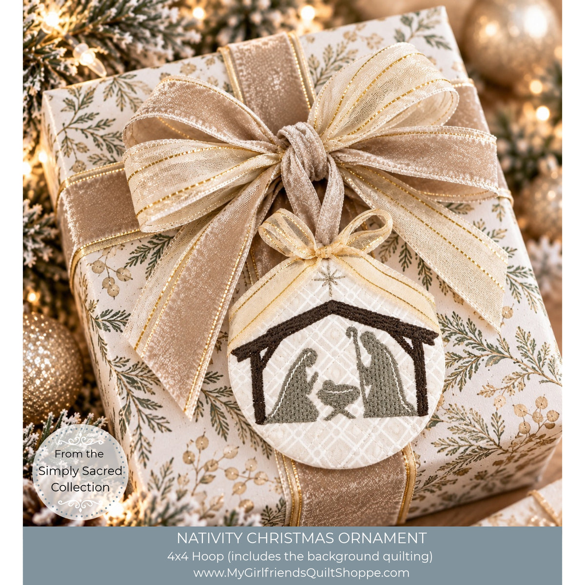 A wrapped gift box with a large beige and gold ribbon bow and a hanging circular ornament featuring a navy and olive green embroidered nativity scene. The background is softly blurred with holiday lights and ornaments, and text at the bottom reads 'NATIVITY CHRISTMAS ORNAMENT' with a quilt shop URL.
