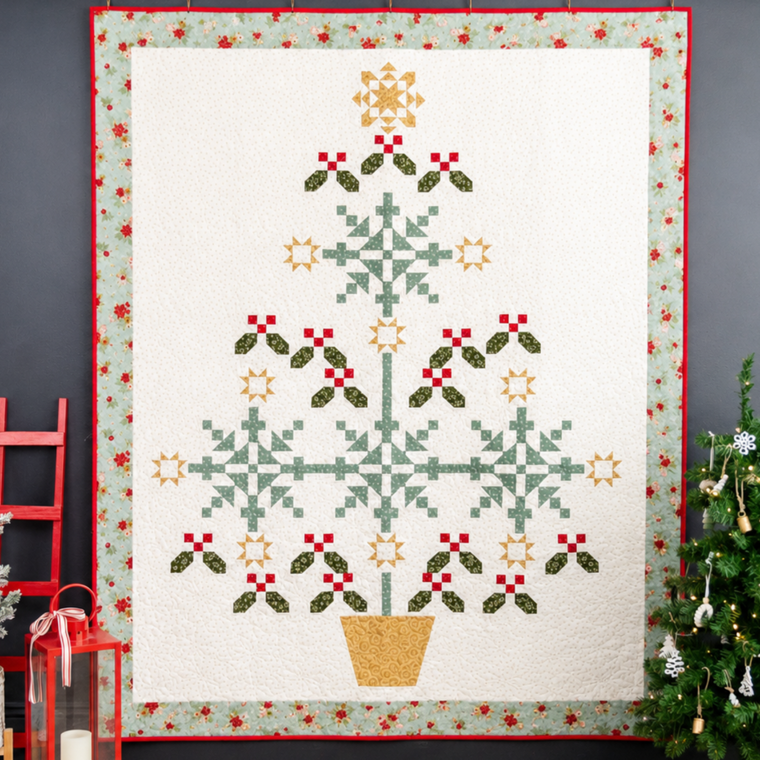 Christmas-themed quilt with tree design on a dark wall with decorative elements.