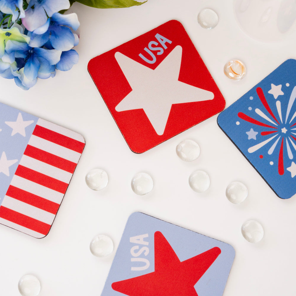 Set of four coasters with star designs and 'USA' text, surrounded by blue flowers and decorative beads.