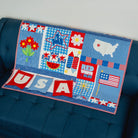 Children's quilt with patriotic designs on a blue couch