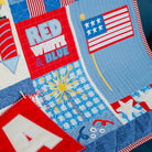 Quilt with patriotic designs including stars, flags, and fireworks.