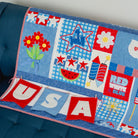 Children's quilt with patriotic designs on a blue couch