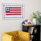 Yellow armchair in a room with a bookshelf and decorative items.
