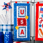 Decorative kitchen towels with 'USA' design on a stand with a checkered tablecloth and jars.