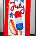 Decorative banner with July text, American flag, stars, hot dog, and popsicle on a red background.
