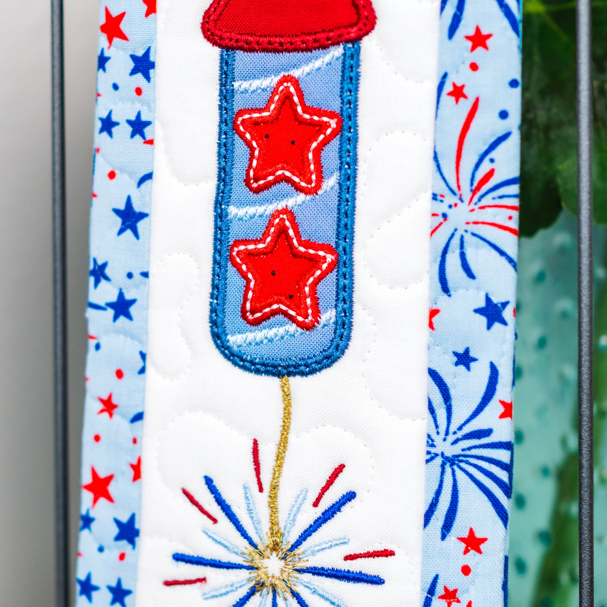 Decorative ribbon with red stars and blue fireworks on a white background