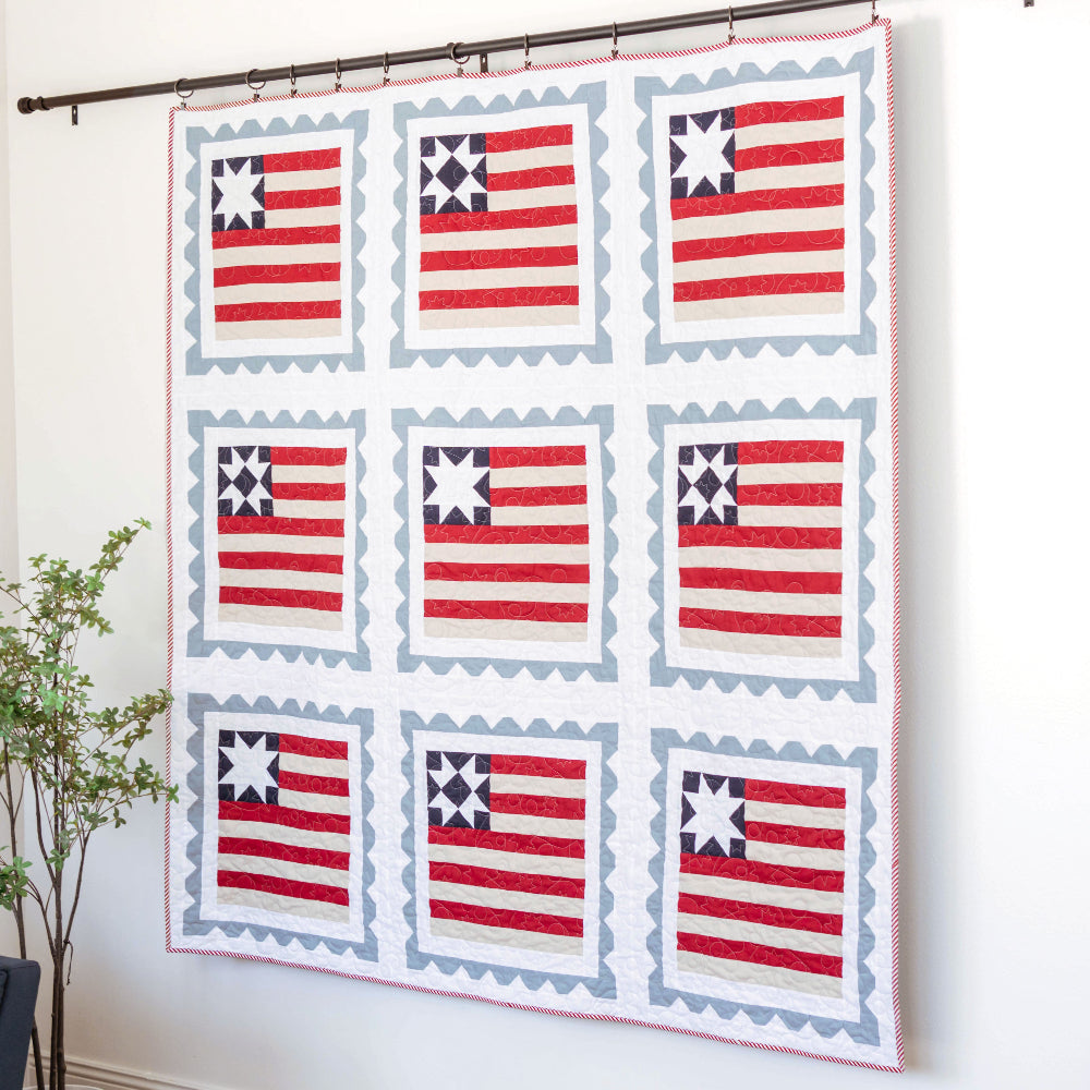 Quilt with American flag pattern hanging on a wall